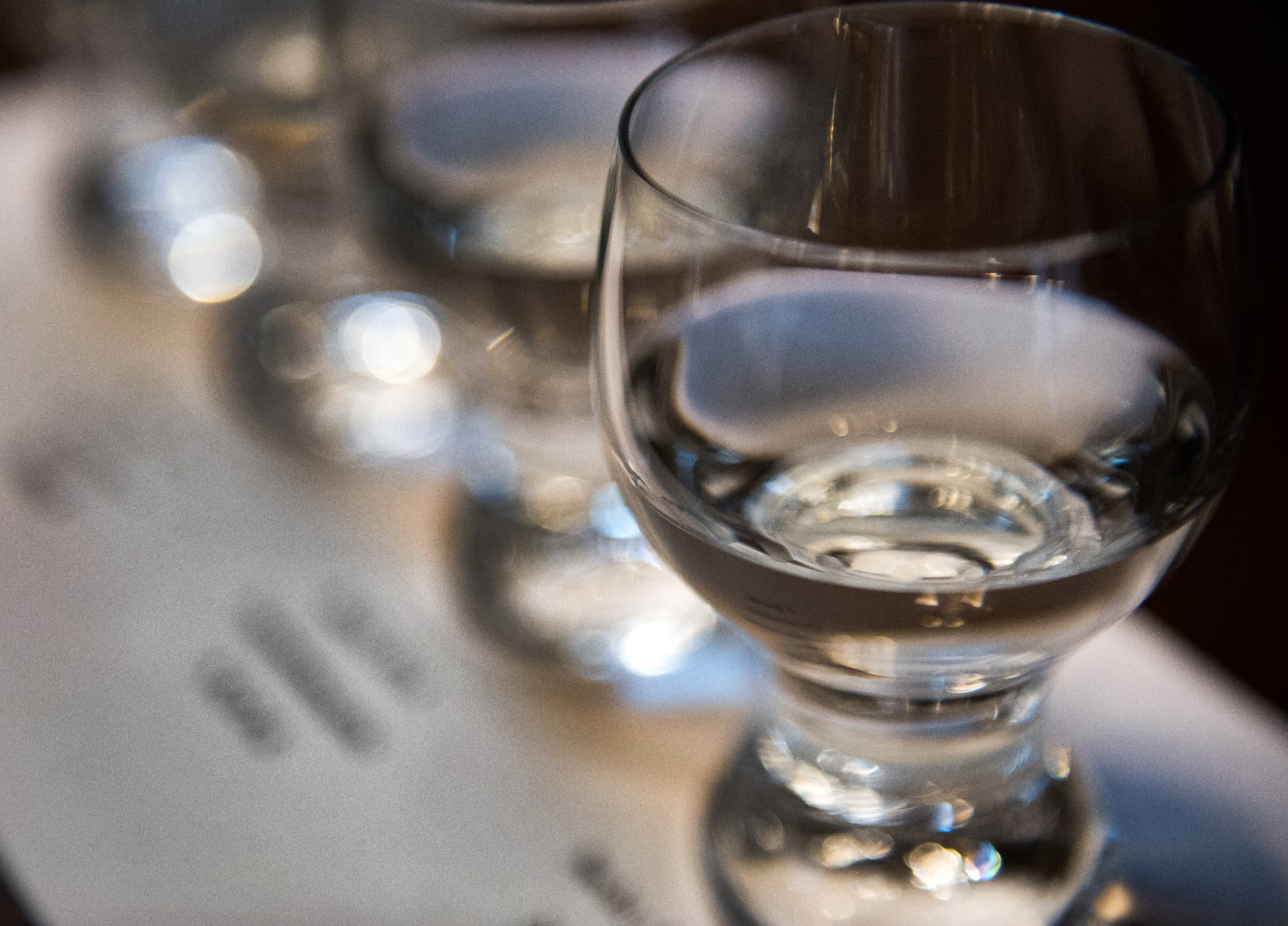 Row of sake tasting glasses on a counter