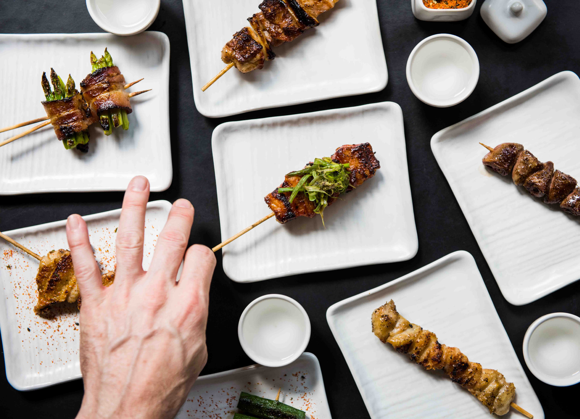 Assorted yakitori skewers plated for sharing